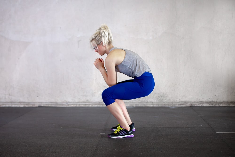 woman hunching back during a squat