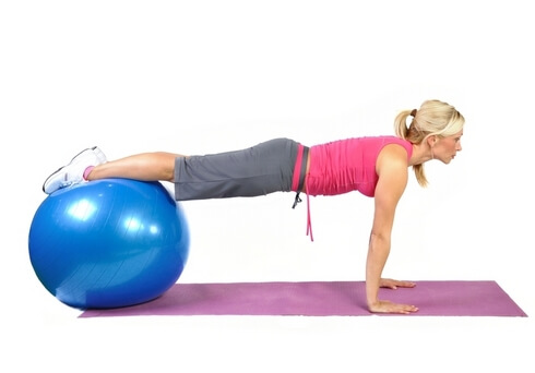 Fit young female pilates instructor showing different exercises